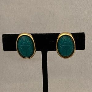 Vintage gold tone oval shaped clip earrings with green scarab centers